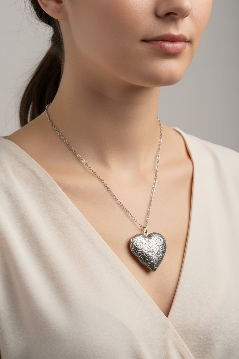 Silver heart-shaped locket necklace on a model