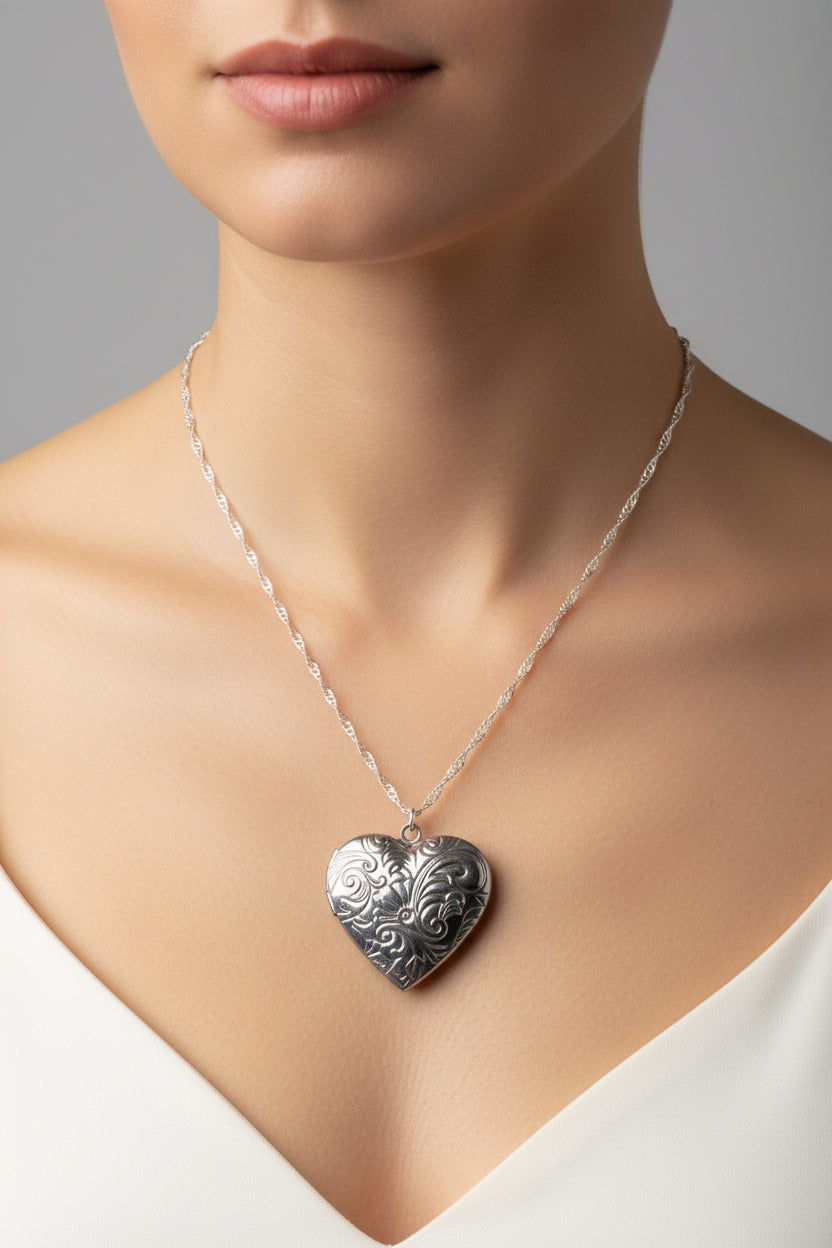 Silver heart-shaped locket on water wave necklace on a model