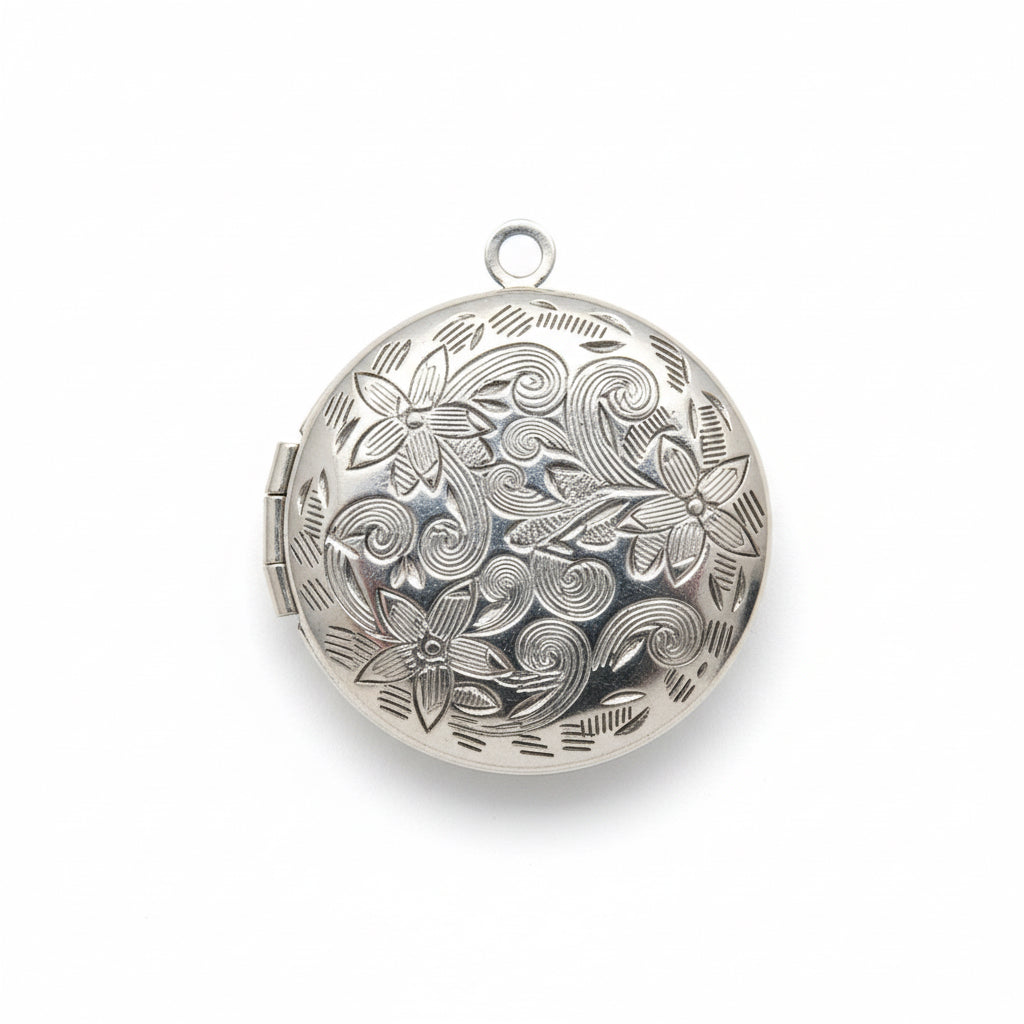 Silver locket with intricate design on a white background