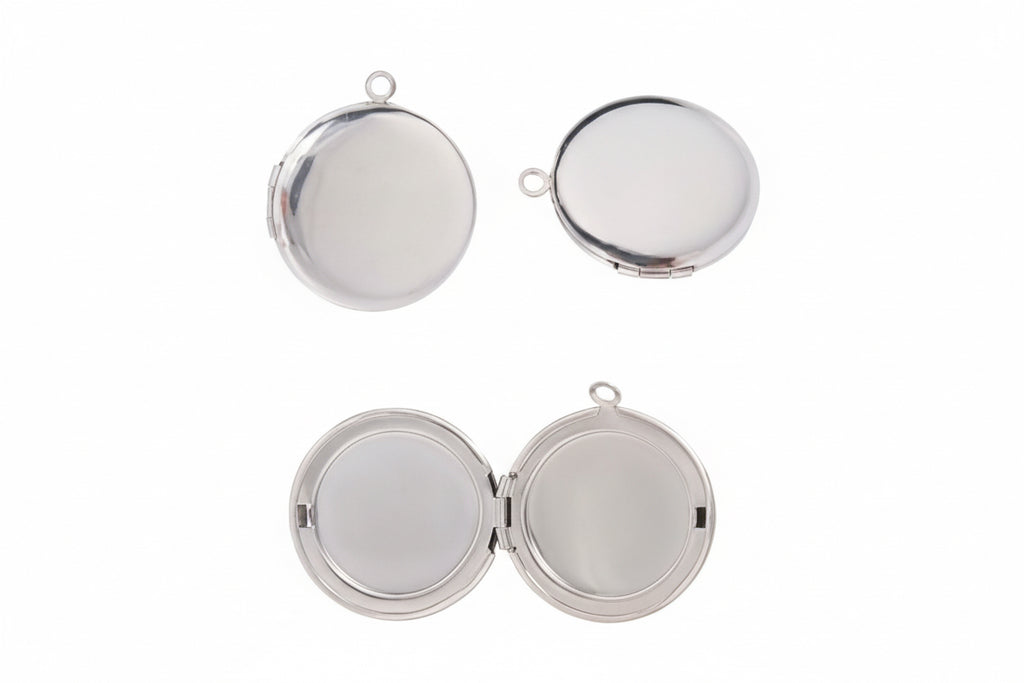 Silver stainless steel plain round lockets a white background