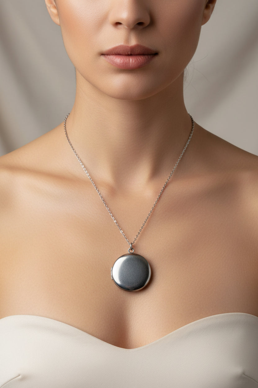 Silver necklace with a round locket on a model