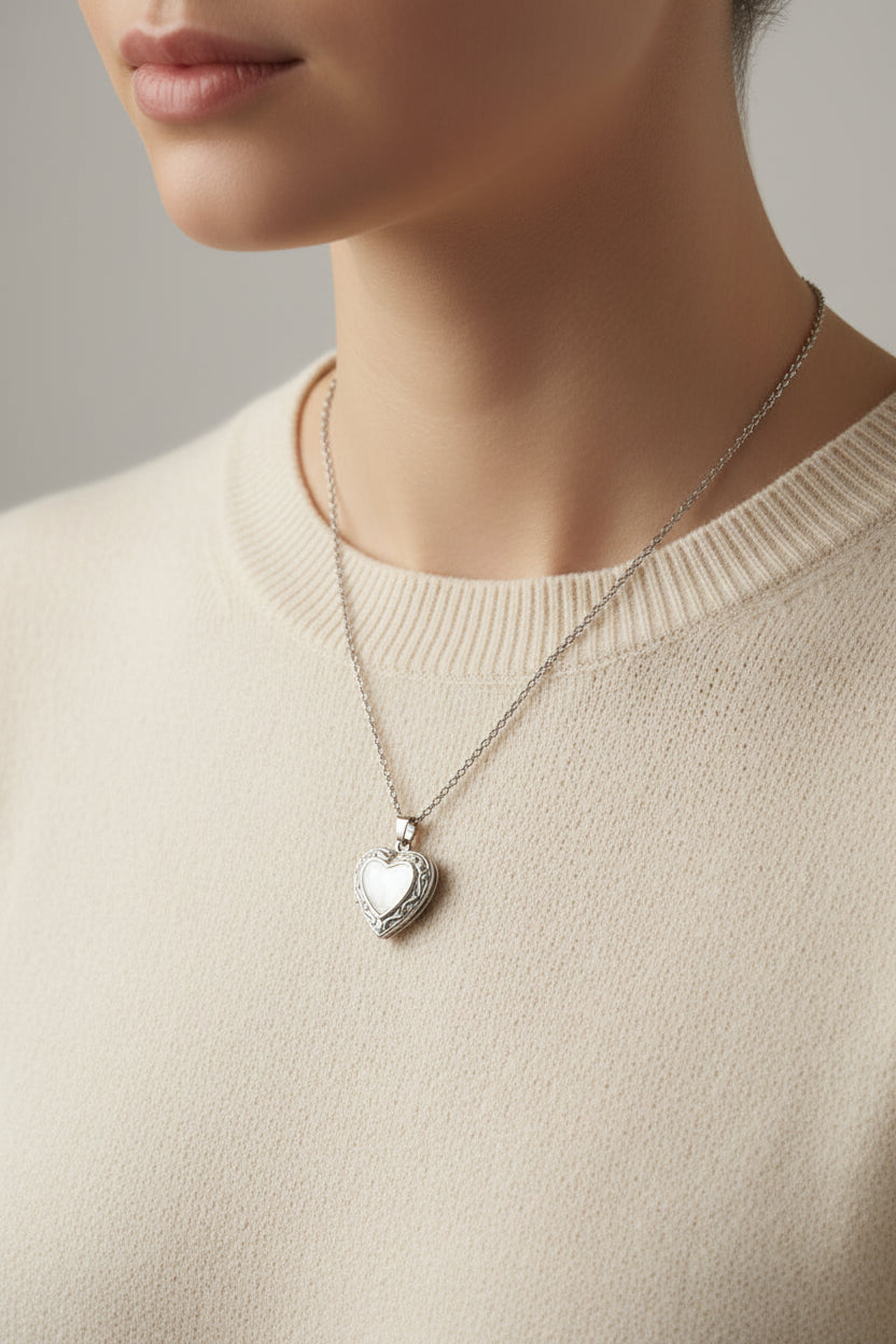 Heart-shaped locket on chain link necklace on a model 