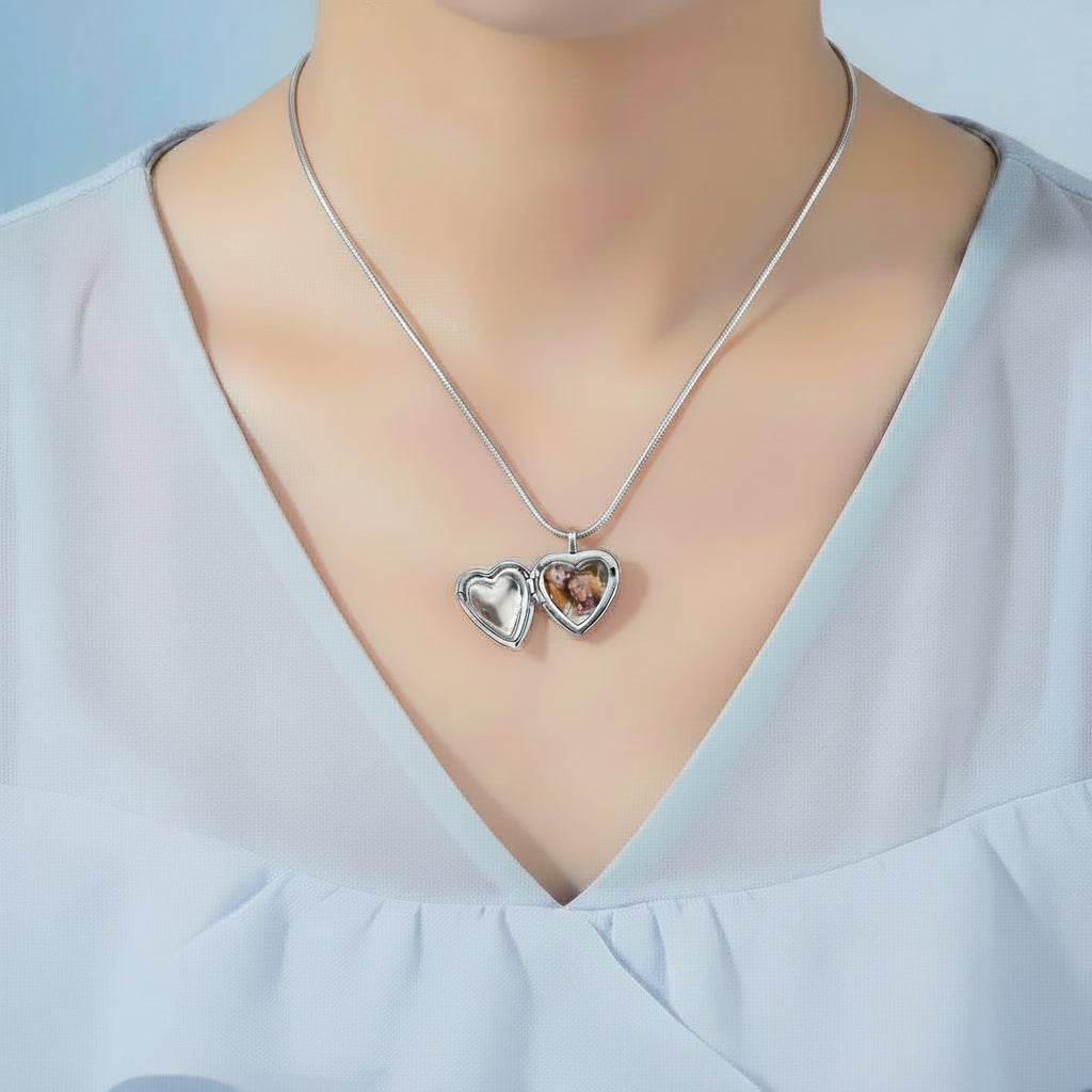 Silver snake chain necklace with a heart locket on a model