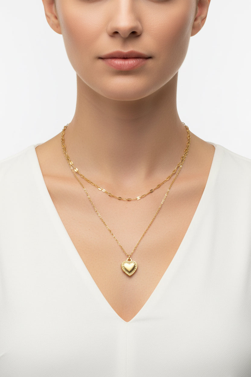 Gold heart-shaped pendant necklace on a model