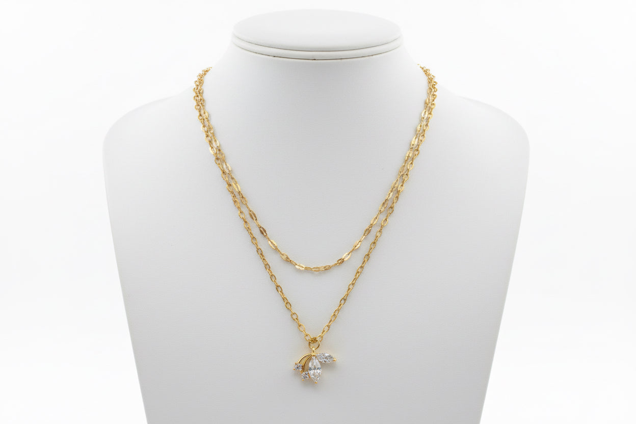 Gold chain necklace with a pendant on a mannequin