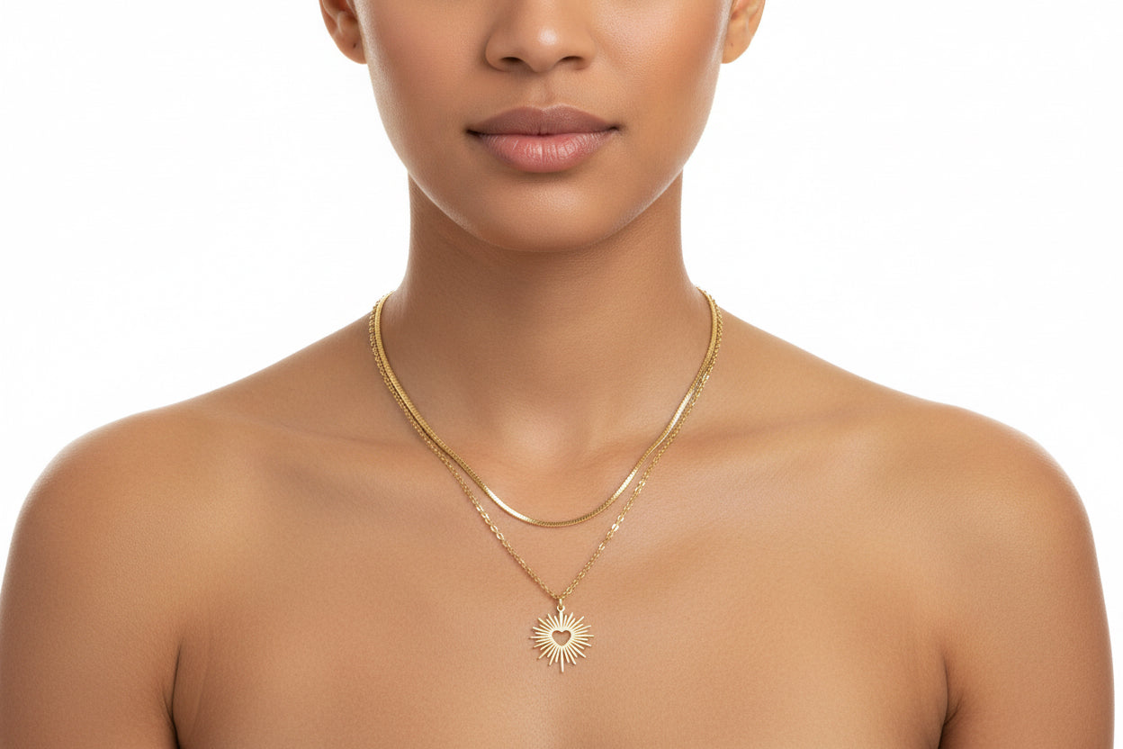 Gold necklace with a sun-shaped pendant on a model