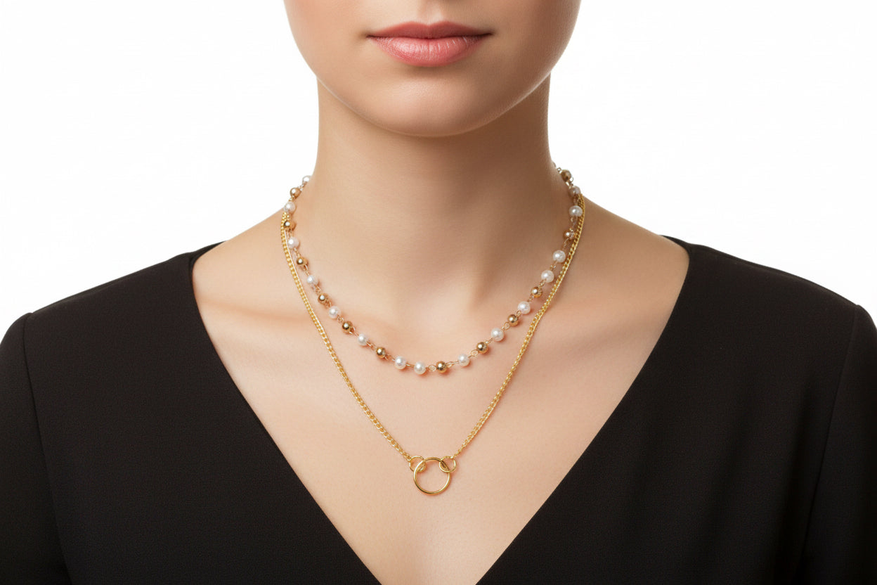 Two gold necklaces on a model 