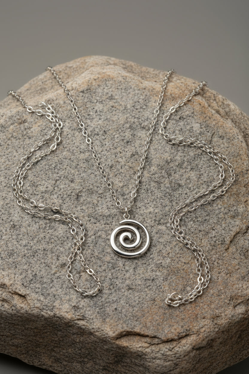 Silver spiral pendant necklace on a large stone
