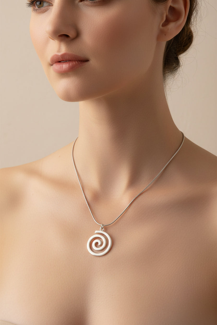 Necklace with a silver spiral pendant on a model