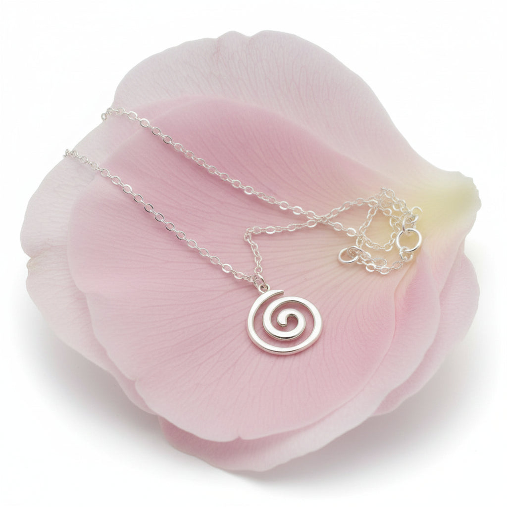 Silver stainless steel spiral pendant necklace on a large petal