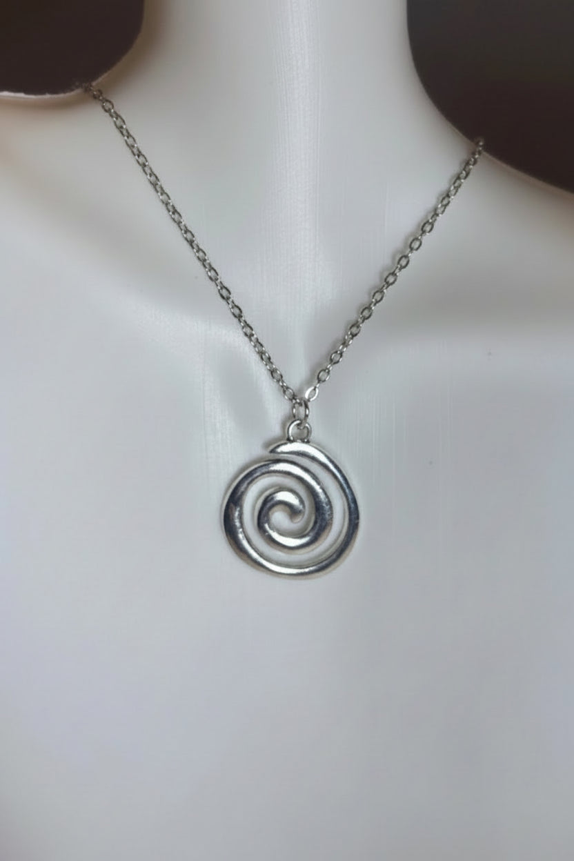 Silver spiral pendant necklace on a mannequin neck