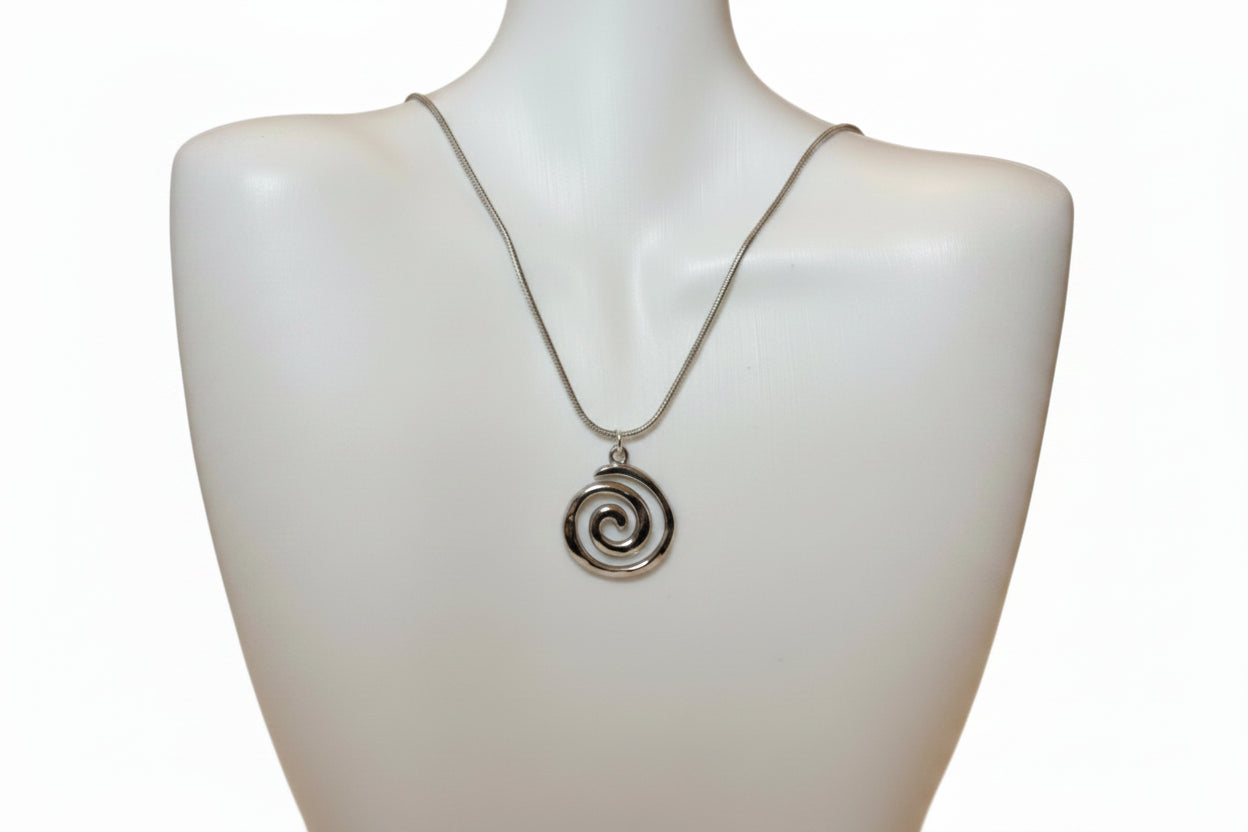 Silver spiral pendant necklace on a mannequin neck