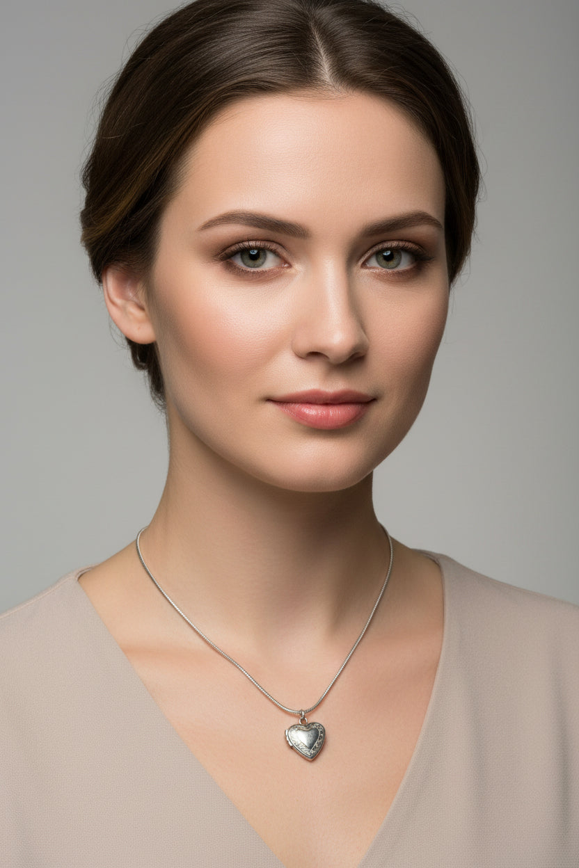 Model wearing stainless steel heart-shaped locket on a snake chain necklace