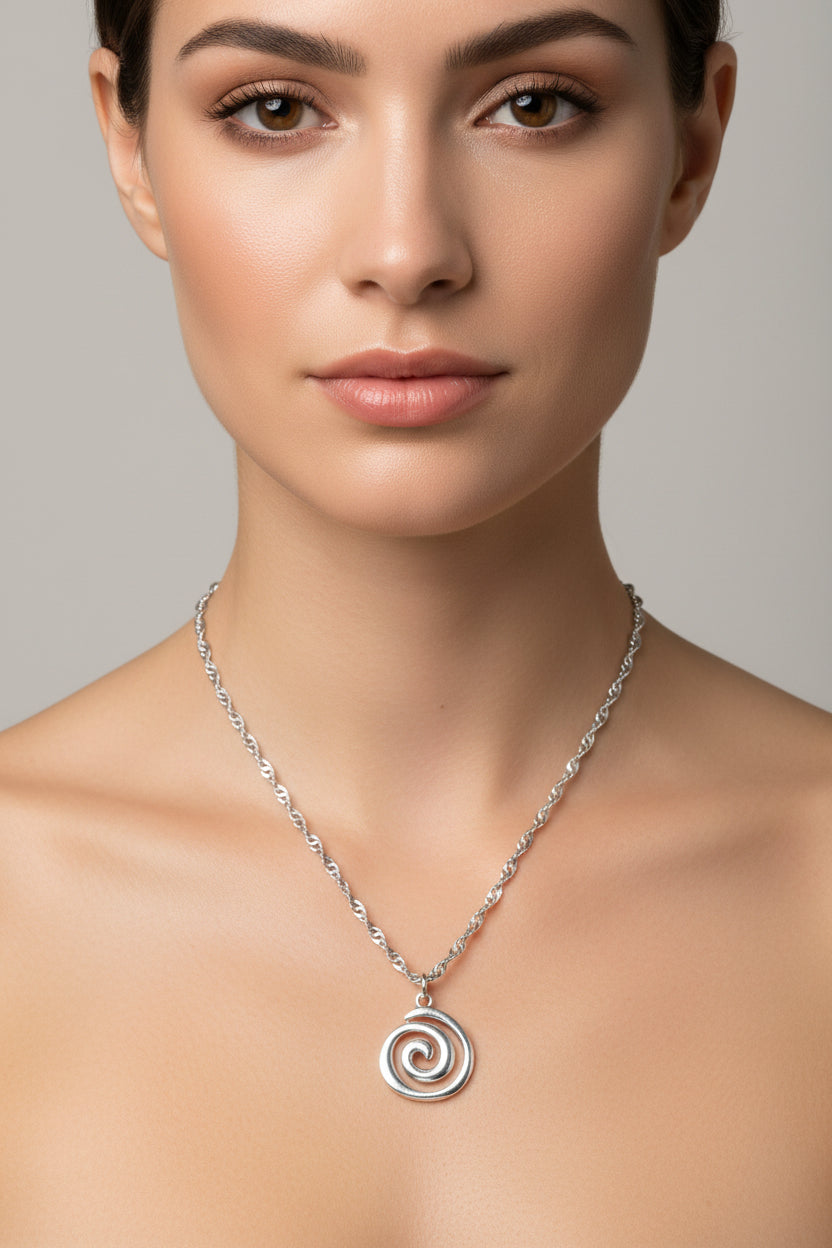 Silver necklace with a spiral pendant on a model