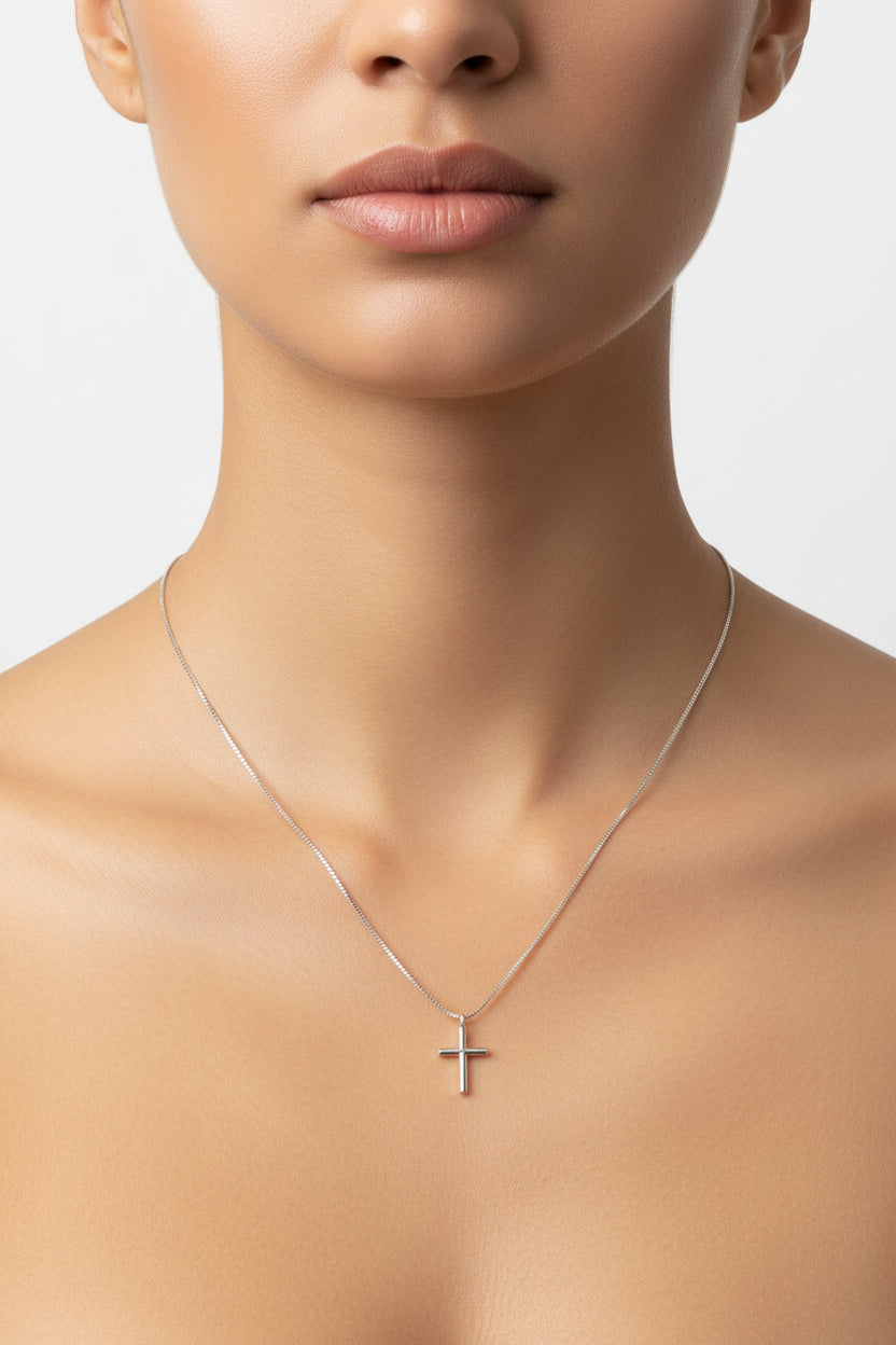 Silver necklace with a cross pendant on a model