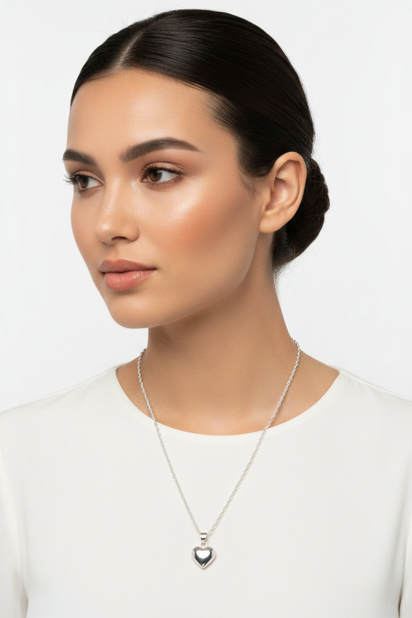 Silver heart-shaped pendant necklace on a model 
