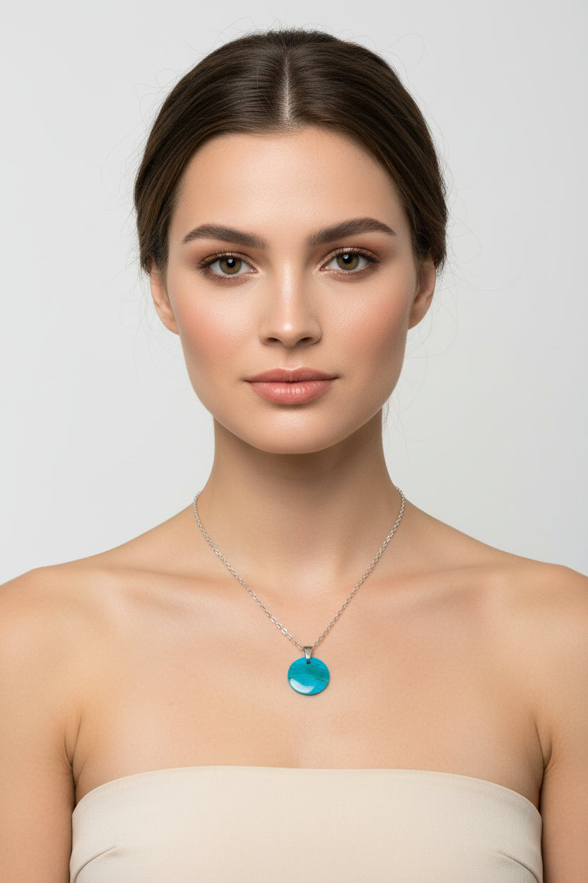 Necklace with a blue pendant on a model's neck against a white background