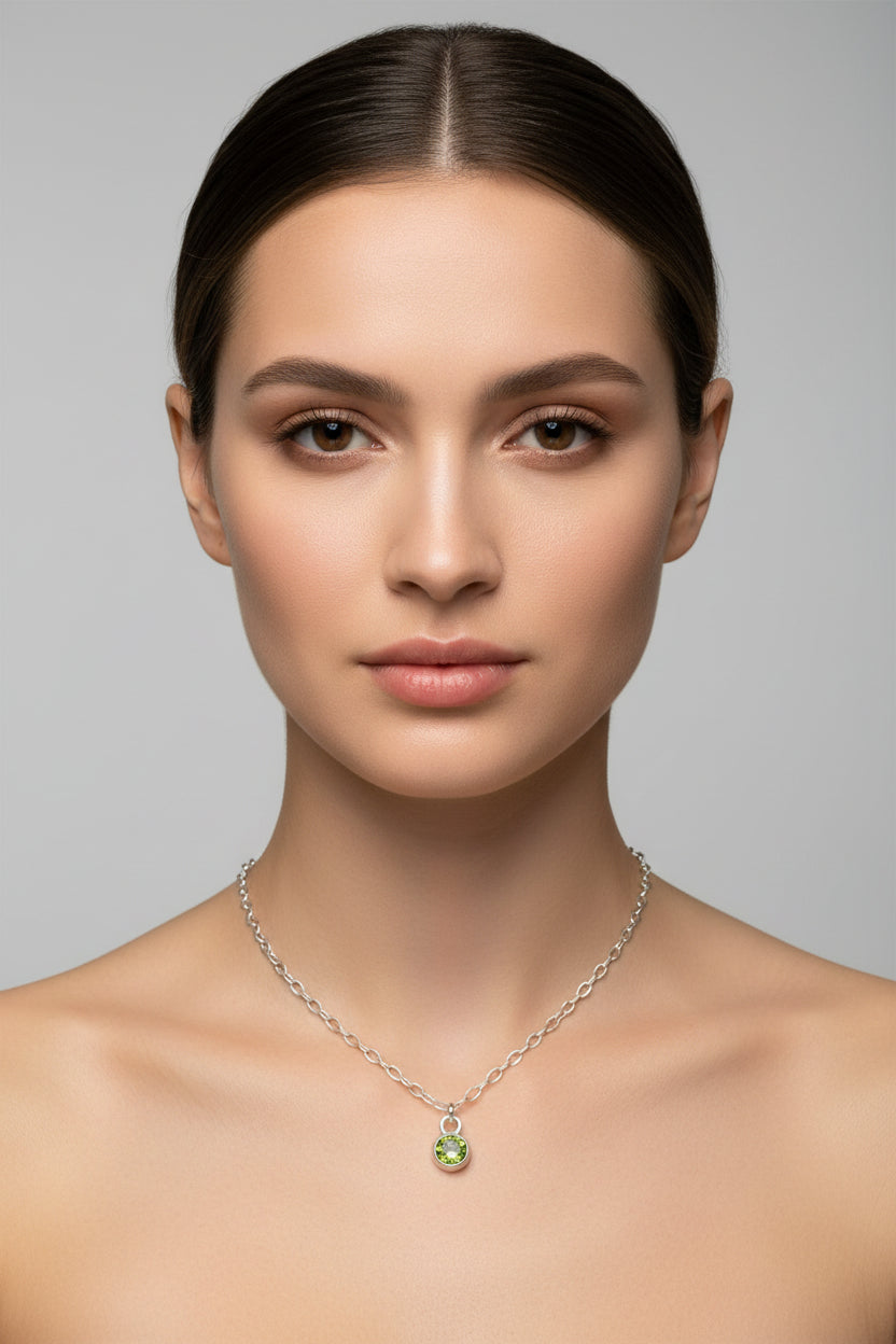 Necklace with a green birthstone pendant on a model