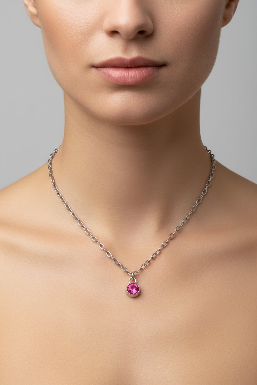 Necklace with a pink birthstone pendant on a model.