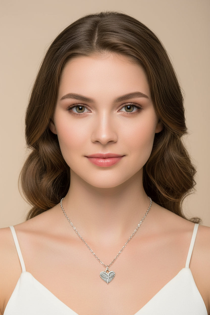 Silver necklace with a heart-shaped pendant on a model