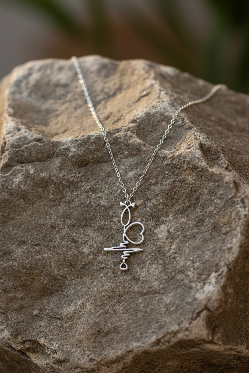 Silver necklace with a heart-shaped pendant on a large stone
