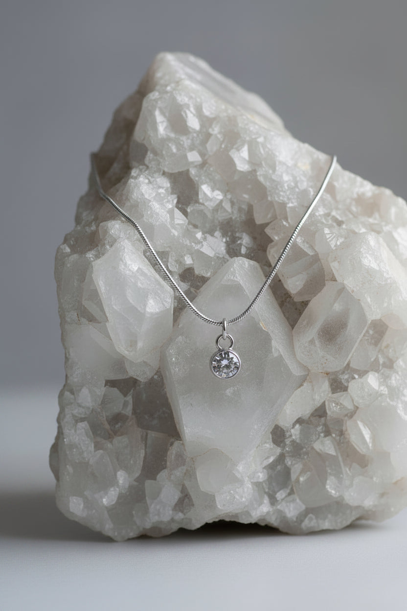 Necklace with a diamond gemstone pendant on a large white rock