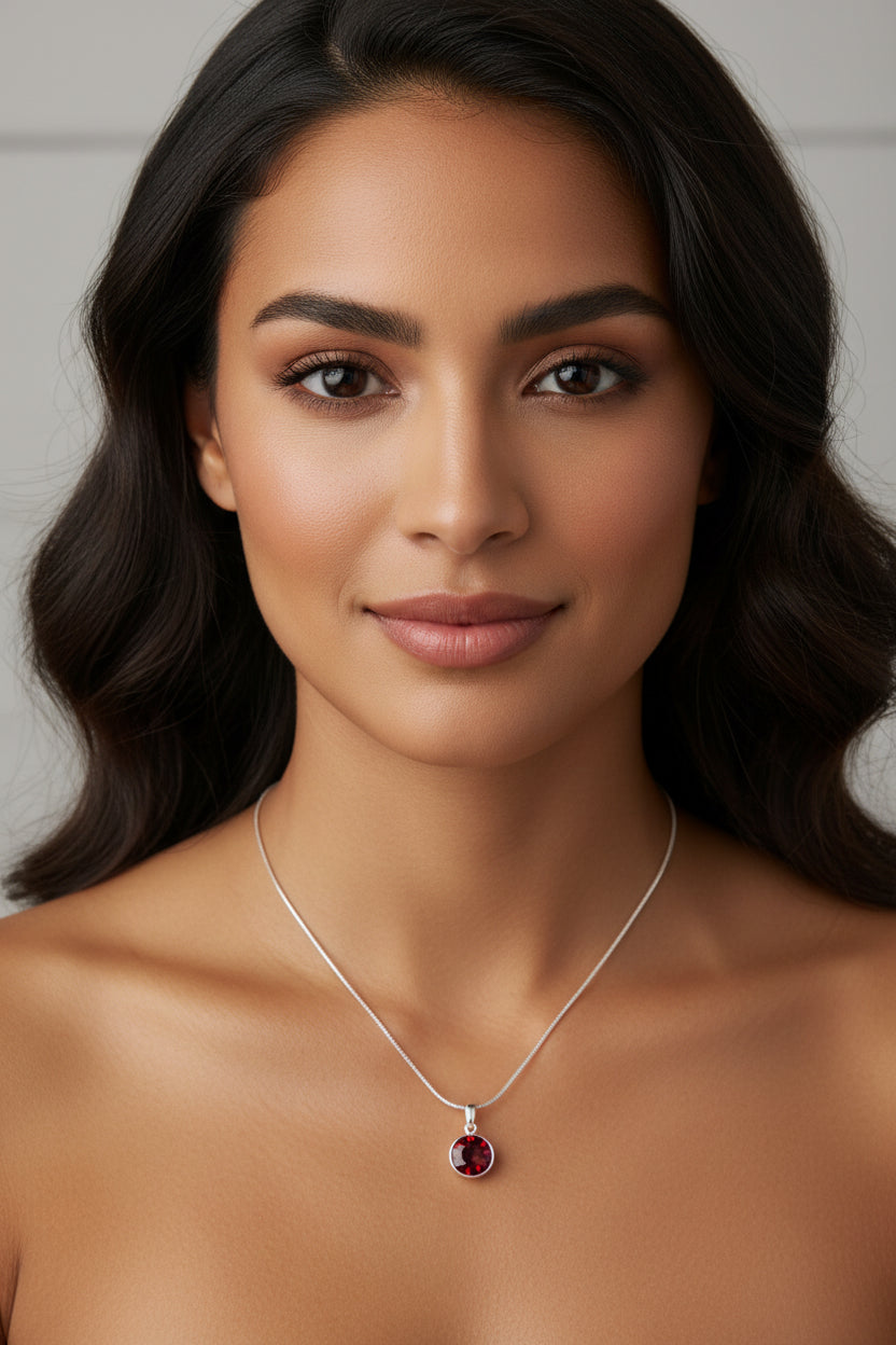 Necklace with a red ruby birthstone pendant on a model
