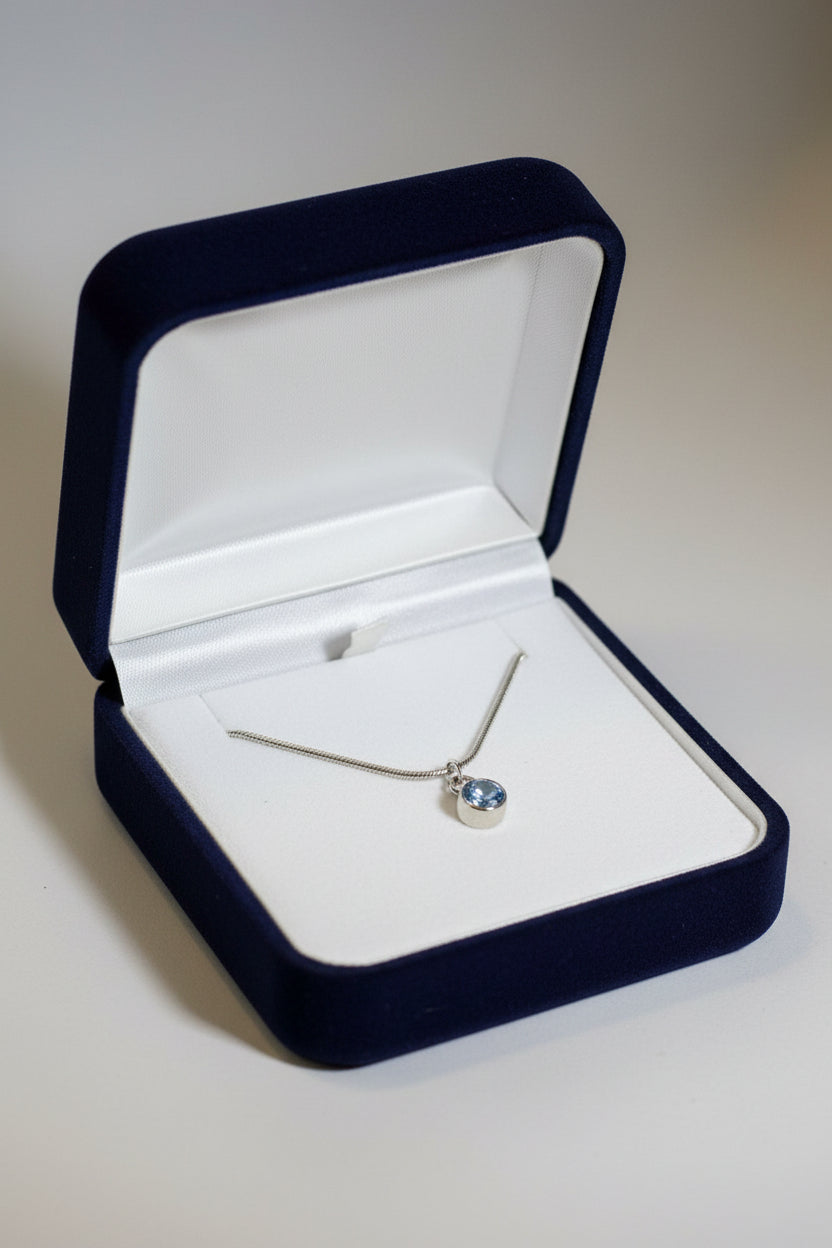 Silver necklace with a blue pendant in black gift box