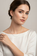 Silver necklace and bracelet set on a model