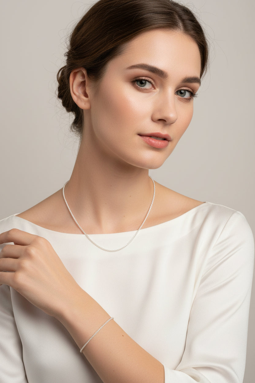 Silver necklace and bracelet set on a model