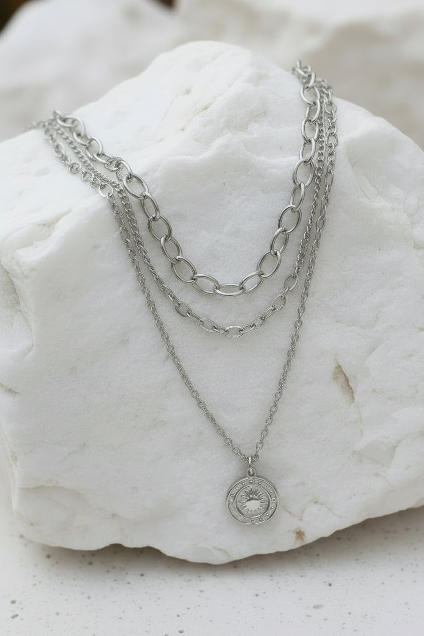 Silver chain necklace with a pendant on a large white stone