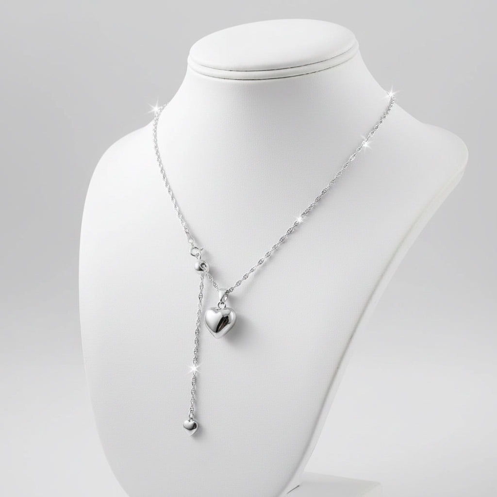 Necklace and heart pendant on white mannequin 
