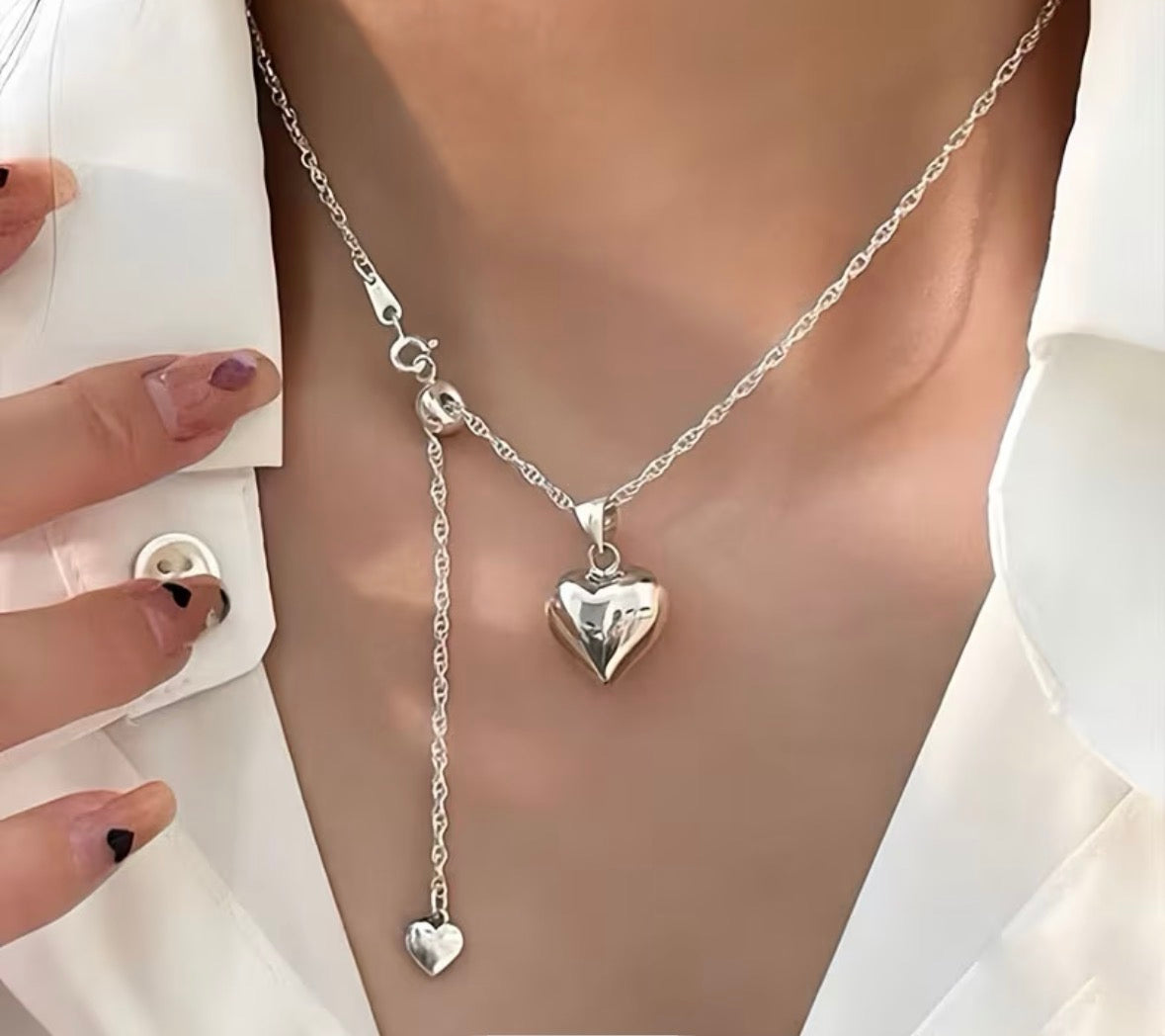 Model wearing sterling silver heart adjustable necklace