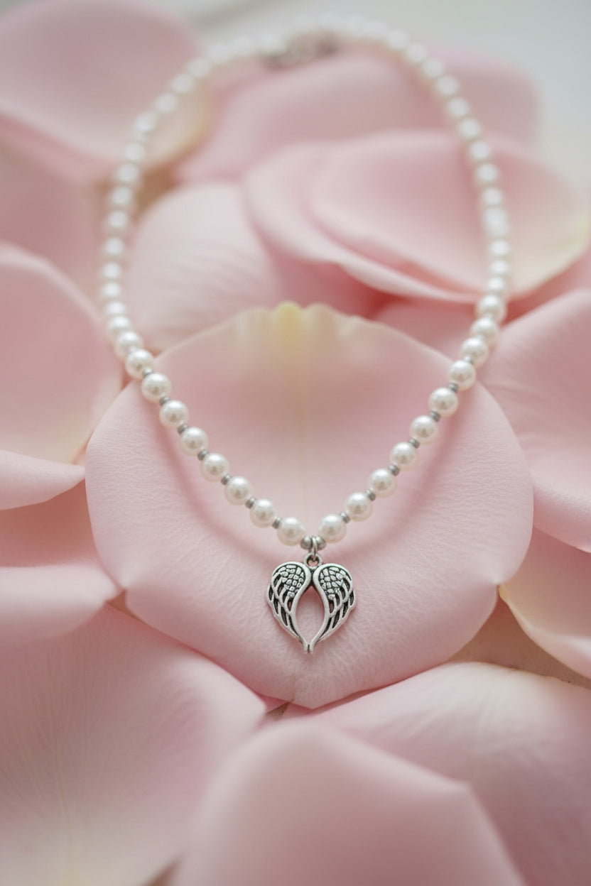 Pearl necklace with a heart pendant on a large pale pink petal