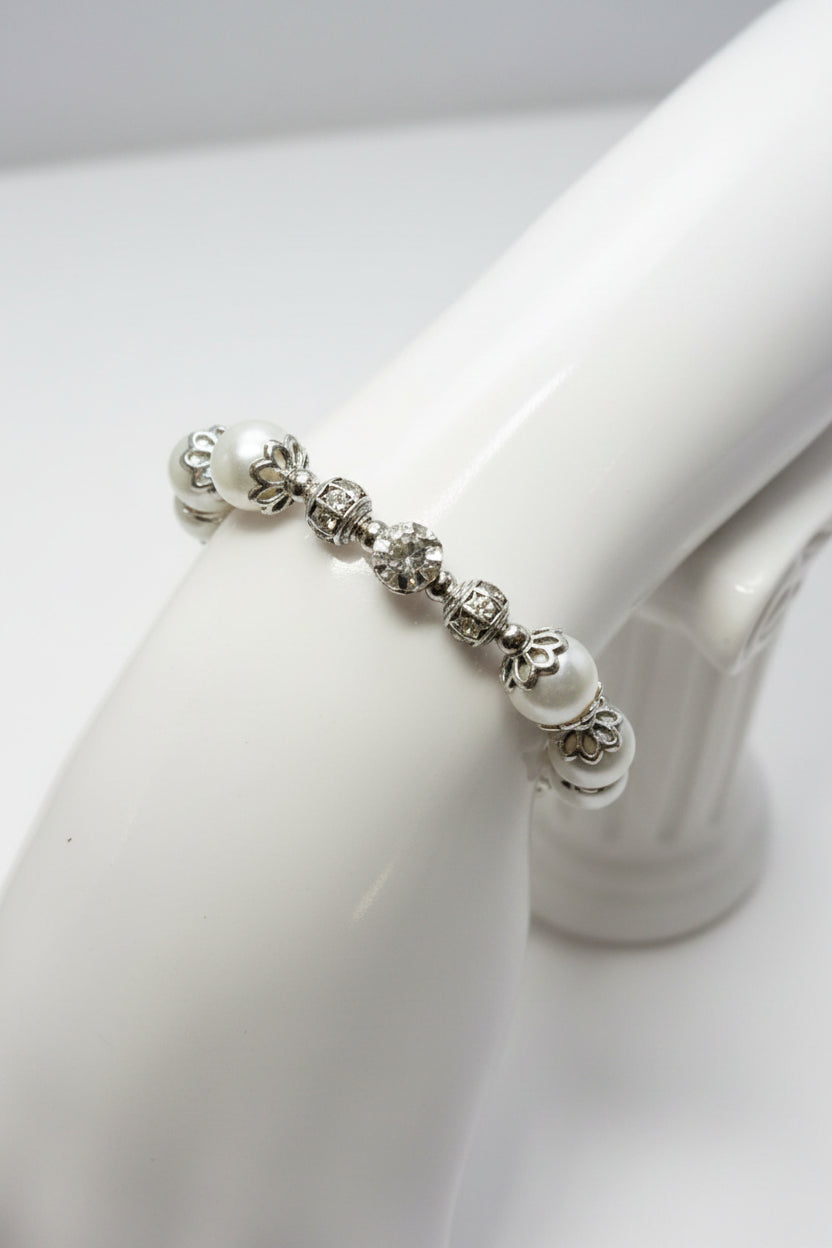 Silver bracelet with pearls on a white mannequin hand