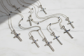 Silver cross necklaces on a white background